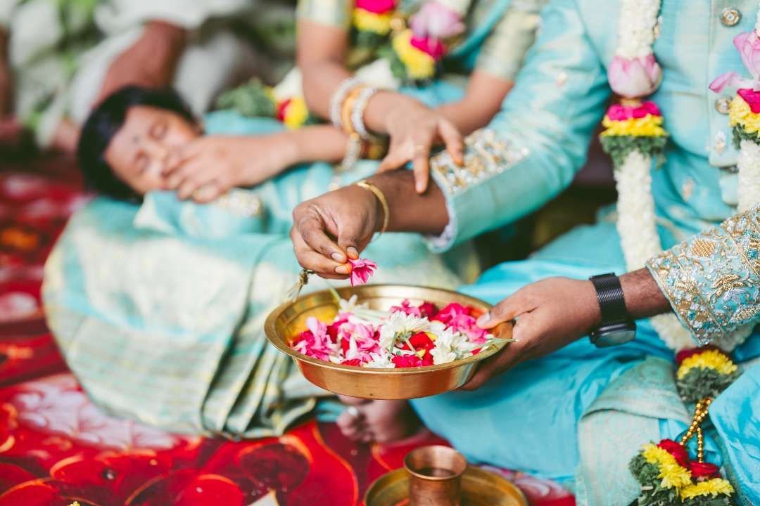 Family gathered around a baby during a naming ceremony ritual in Bengaluru